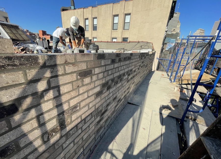 Rooftop parapet wall repair in progress